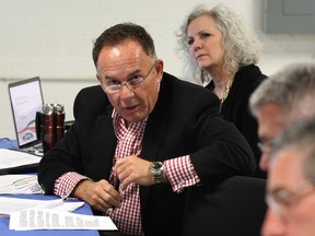 EnWin board member Marty Komsa raises a question during the first EnWin board meeting open to the public February 26, 2014. Barbara Peirce-Marshall, behind, listens during the meeting held in the basement of EnWin's Ouellette Avenue office. (NICK BRANCACCIO/The Windsor Star)