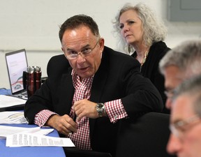 EnWin board member Marty Komsa raises a question during the first EnWin board meeting open to the public February 26, 2014. Barbara Peirce-Marshall, behind, listens during the meeting held in the basement of EnWin's Ouellette Avenue office. (NICK BRANCACCIO/The Windsor Star)
