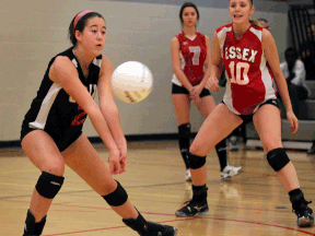 Essex Raider Briallen Pettit, left, returns a shot in front of teammate Emily McCloskey, right, and Brennan line judge Sonia Bobek. (NICK BRANCACCIO/The Windsor Star)