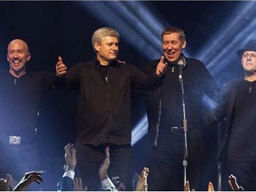 Phil Nolan, far right, who plays drums in the band that often accompanies Prime Minister Stephen Harper, is facing multiple charges of sexual assault and sexual interference. Harper and his band Herringbone receive applause after performing in Toronto on Sunday, December 1, 2013. (Photograph by: THE CANADIAN PRESS/Chris Young , Postmedia News)