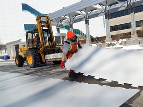 A city of Windsor crew removes the ice from Charles Clark Square in Windsor on Wednesday, February 12, 2014. The city will put real ice back in to the park.                                  (TYLER BROWNBRIDGE/The Windsor Star)