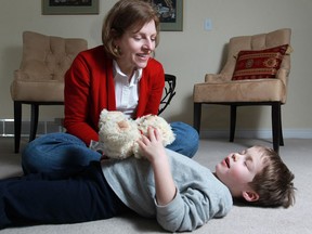 Dr. Carlin Miller, an associate professor at the University of Windsor, practises mindfulness with her son, Laing Miller, 4, at her home, Friday, Feb. 14, 2014.  Miller is developing a mindfulness program for parents and teachers to help with stress reductions and improving focus.  (DAX MELMER/The Windsor Star)