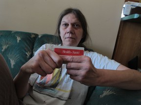 Dianne Whitson, shown here in her Windsor, Ont., home on Wednesday, Feb. 26, 2014, has been told by the Ministry of Health that she is shown as a male on her OHIP card and is being billed for certain medical procedures.  She has tried many times to get the mistake corrected. (JASON KRYK/The Windsor Star)