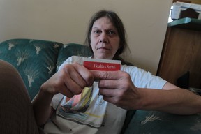 Dianne Whitson, shown here in her Windsor, Ont., home on Wednesday, Feb. 26, 2014, has been told by the Ministry of Health that she is shown as a male on her OHIP card and is being billed for certain medical procedures.  She has tried many times to get the mistake corrected. (JASON KRYK/The Windsor Star)