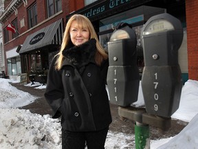 Joan Charette, coordinator, Walkerville BIA, is shown Thursday, Feb. 6, 2014, near coin-operated meters in Windsor, Ont. Walkerville will be the site of new parking meters that run on solar power and accept credit cards. (DAN JANISSE/The Windsor Star)