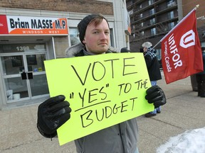 Travis Barron leads a small group of protesters in front of the office of Windsor-West MP Brian Masse in Windsor on Wednesday, February 26, 2014. The group Vote With Windsor is urging Masse to support the federal budget.                 (TYLER BROWNBRIDGE/The Windsor Star)