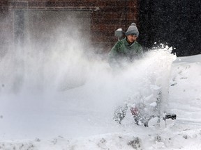 A snow blower sends snow flying as the snow continues to fall in downtown Windsor on Wednesday, February 5, 2014. (TYLER BROWNBRIDGE/The Windsor Star)