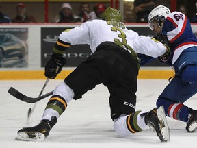 Windsor's Josh Ho-Sang, right, scores while falling down as he's defended by North Bay's Kyle Wood as the Windsor Spitfires host the North Bay Battalions at the WFCU Centre, Sunday, Feb. 9, 2014.  Windsor defeated North Bay 6-5.  (DAX MELMER/The Windsor Star)