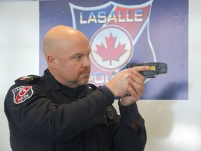 LaSalle Police Service Sgt. Mike Foreman displays his X26 model conductive energy weapon, more commonly by the brand name Taser, on Friday. Forman is one of two instructors with the LaSalle force. Julie Kotsis/The Windsor Star