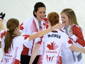 Canadian team members: Kaitlyn Lawes, left, Jill Officer, Dawn McEwen and Jennifer Jones celebrate winning gold in the Women's Curling Gold Medal Game Canada vs Sweden at the Ice Cube Curling Center during the Sochi Winter Olympics on February 20, 2014.    (JUNG YEON-JE/AFP/Getty Images)