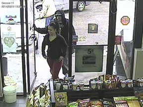 Surveillance footage of two suspects wanted in connection with a stolen credit card are pictured on Feb. 17, 2014. (Handout/The Windsor Star)