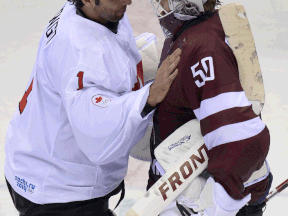 Latvia goalkeeper Kristers Gudlevskis, right, talks to Canada  goalkeeper Roberto Luongo at the end of the men's quarter-final. (NEMENOV/AFP/Getty Images)