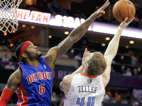 Detroit's Josh Smith, left, stretches to block Charlotte's Cody Zeller Wednesday in Charlotte, N.C. (AP Photo/Bob Leverone)