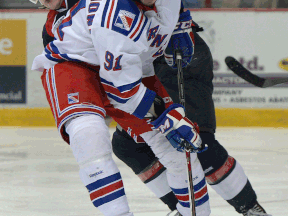 Windsor's Remy Giftopoulos, left, and Kitchener's Matia Marcantuoni battle for the puck Thursday at the WFCU Centre. (DAN JANISSE/The Windsor Star)