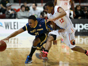 Saint John's Doug Herring Jr., left, is guarded by Windsor's Darren Duncan Friday at the WFCU Centre. (DAN JANISSE/The Windsor Star)