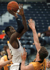 Windsor's Lien Phillip, left, takes a shot over Waterloo's Mike Helsby at the St. Denis Centre. (DAX MELMER/The Windsor Star)