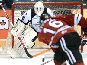 Tecumseh's Kerby Rychel, right, takes a shot on Windsor goalie Alex Fotinos Friday in Guelph. (TONY SAXON/Guelph Mercury)