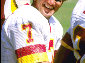 Washington quarterback Joe Theismann rests on the sideline during a pre-season game against the Los Angeles Raiders.  (Jonathan Daniel photo)