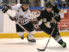 LaSalle's Dylan Denomme, right, is checked by Sarnia's Bobby King at the Vollmer Centre. (DAN JANISSE/The Windsor Star)