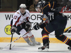 Windsor's Ben Johnson, left, checks Barrie's Aaron Ekblad at the WFCU Centre. (DAN JANISSE/The Windsor Star)