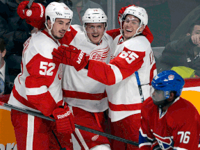 Detroit's Gustav Nyquist, centre, celebrates his winning goal with teammates  Jonathan Ericsson, left, and Danny DeKeyser. (THE CANADIAN PRESS/Ryan Remiorz)