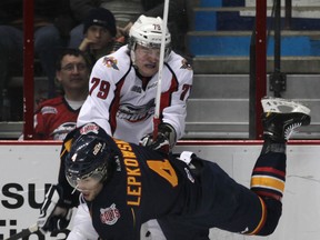 Windsor's Ty Bilcke, top, hits Barrie's Alex Lepkowski at the WFCU Centre. (DAN JANISSE/The Windsor Star)