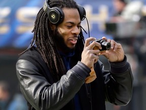 Seattle cornerback Richard Sherman takes a photo of the field during a brief visit by the team to MetLife Stadium Saturday. (AP Photo/Jeff Roberson)