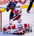 Vancouver's Ryan Kesler, left, checks Detroit's Danny DeKeyser in front of Wings goalie Jimmy Howard. (THE CANADIAN PRESS/Jonathan Hayward)