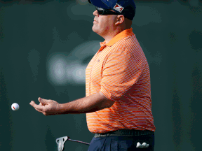 Kevin Stadler flips his ball to his caddie after putting out at the 16th green during the final round of the Phoenix Open golf tournament in Scottsdale. (AP Photo/Ross D. Franklin)