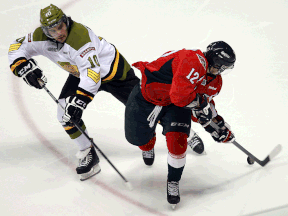 Windsor's Ben Johnson, right, is checked by Brampton's Francis Menard at the WFCU Centre last year. (TYLER BROWNBRIDGE/The Windsor Star)