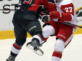 Windsor's Ty Bilcke, checks, Michael Bunting of the Greyhounds at the WFCU Centre. (TYLER BROWNBRIDGE/The Windsor Star)