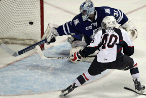 Windsor's Ryan Moore, right, scores a goal on netminder Spencer Martin of the Steelheads at the WFCU Centre. (NICK BRANCACCIO/The Windsor Star)