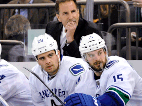 Vancouver Canucks coach John Tortorella looks on with Tom Sestito, left, and Brad Richardson against the New York Rangers at Madison Square Garden. (AP Photo/Bill Kostroun)