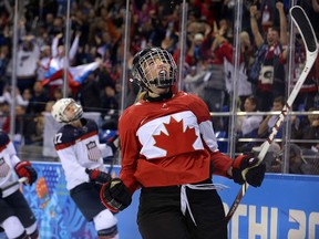 Canada's Meghan Agosta-Marciano celebrates after scoring her team's third goal during the Women's Ice Hockey Group A match between Canada and USA at the Sochi Winter Olympics on February 12, 2014 at the Shayba Arena.   AFP PHOTO / ALEXANDER NEMENOV