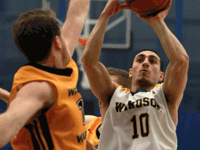 Windsor's Mike Rocca, right, is guarded by Waterloo's Mike Helsby at the St. Denis Centre. (DAX MELMER/The Windsor Star)