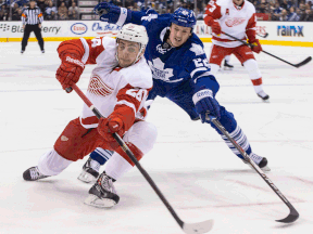 Detroit's Tomas Jurco, left, is checked by Toronto's Jerred Smithson. (THE CANADIAN PRESS/Chris Young)