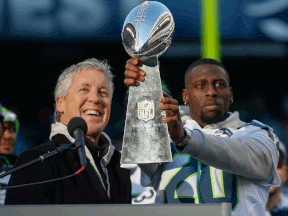 Seahawks coach Pete Carroll, left, and running back Jeremy Lane hold the Lombardi Trophy during ceremonies following the Super Bowl XLVIII Victory Parade at CenturyLink Field. (Photo by Otto Greule Jr/Getty Images)