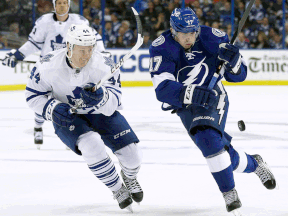 Tampa Bay's Alex Killorn, right, is checked by Toronto's Morgan Rielly Thursday in Tampa, Fla. (AP Photo/Chris O'Meara)