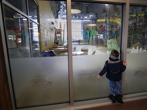 The Adventure Bay Water Park was closed Tues. Feb. 18, 2014, due to air quality issues. A young boy looks into the park after his family was told it was closed.  (DAN JANISSE/The Windsor Star)