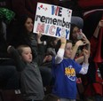 Two young fans hold up a sign in honour of Mickey Renaud Tuesday, Feb. 18, 2014, at the WFCU Centre in Windsor. against London. The club marked the sixth anniversary of the former captain's death. (DAN JANISSE/The Windsor Star)