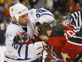 Maple Leaf Tie Domi, left, punches New Jersey's Jay Pandolfo in Toronto March 30, 2002. Simon & Schuster Canada announced Tuesday that it will publish Domi's forthcoming memoir. (THE CANADIAN PRESS/Kevin Frayer)