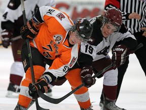 Essex forward Daniel Slipchuk, left, battles Dresden's Blake Padbury in Essex. (TYLER BROWNBRIDGE/The Windsor Star)