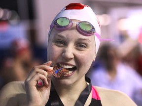 Windsor Essex Swim Team member Sadie Fazekas celebrates with her bronze medal Feb. 13, 2014, at the Eastern Canadian Swimming Championships in Windsor, Ont.   (DAN JANISSE/The Windsor Star)