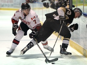 Leamington's Cole Chevalier, left, and LaSalle's Andrew Burns battle during their game Wed. Feb. 12, 2014, at the Vollmer Centre in LaSalle. The Flyers won 4-3 in overtime. (DAN JANISSE/The Windsor Star)