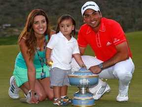 Jason Day, right, poses with his wife Ellie, left, and son Dash after Day defeated Victor Dubuisson on the 23rd hole of the Accenture Match Play Championship at The Golf Club at Dove Mountain on February 23, 2014 in Marana, Ariz.  (Sam Greenwood/Getty Images)