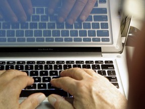 Hands at a keyboard in a 2013 file photo. (Damian Dovarganes / AP)