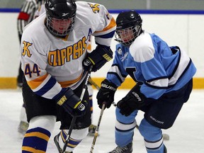 Kennedy's Colin Robinson, left, cuts around Massey's Steven Shields during high school hockey at Adie Knox Arena Monday, February 3, 2014. (TYLER BROWNBRIDGE/The Windsor Star)