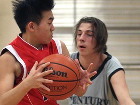 Ste. Cecile's Alan Chang, left, and Century's Ryan Parent battle for the ball Mon. Feb. 2, 2014, during high school basketball action at Ste. Cecile in Windsor. (DAN JANISSE/The Windsor Star)