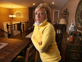 Tina Michaluk is shown Mon. Feb. 4, 2014, at her Belle River home, is a Hydro One customer who was forced to pay a $900 utility bill at her uninhabited house following a fire, to avoid getting her power cut off. (DAN JANISSE/The Windsor Star)
