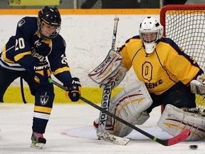 Windsor's Erin Noseworthy, left, gets in close on Queen's goalie Mel Dodd-Moher during Game 1 of their OUA playoff opener Thurs. Feb. 13, 2014, in Windsor.  (DAN JANISSE/The Windsor Star)